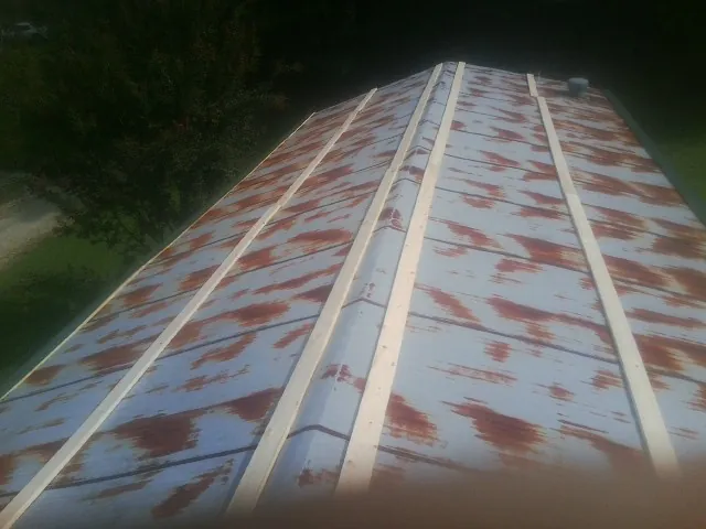 Rusted metal roof panels with new wood purlins before replacement — Storm Damage Roof Repair in South Bloomingville by Roofing Brothers