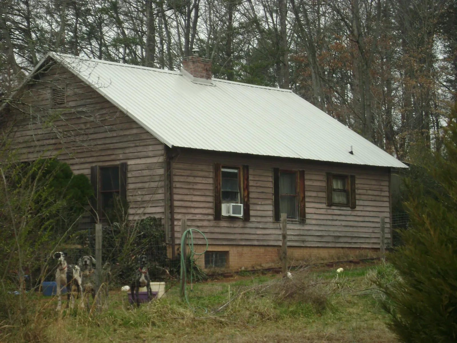 White metal roof on an old wood sided farmhouse, from a Metal Roof Installation job in South Bloomingville